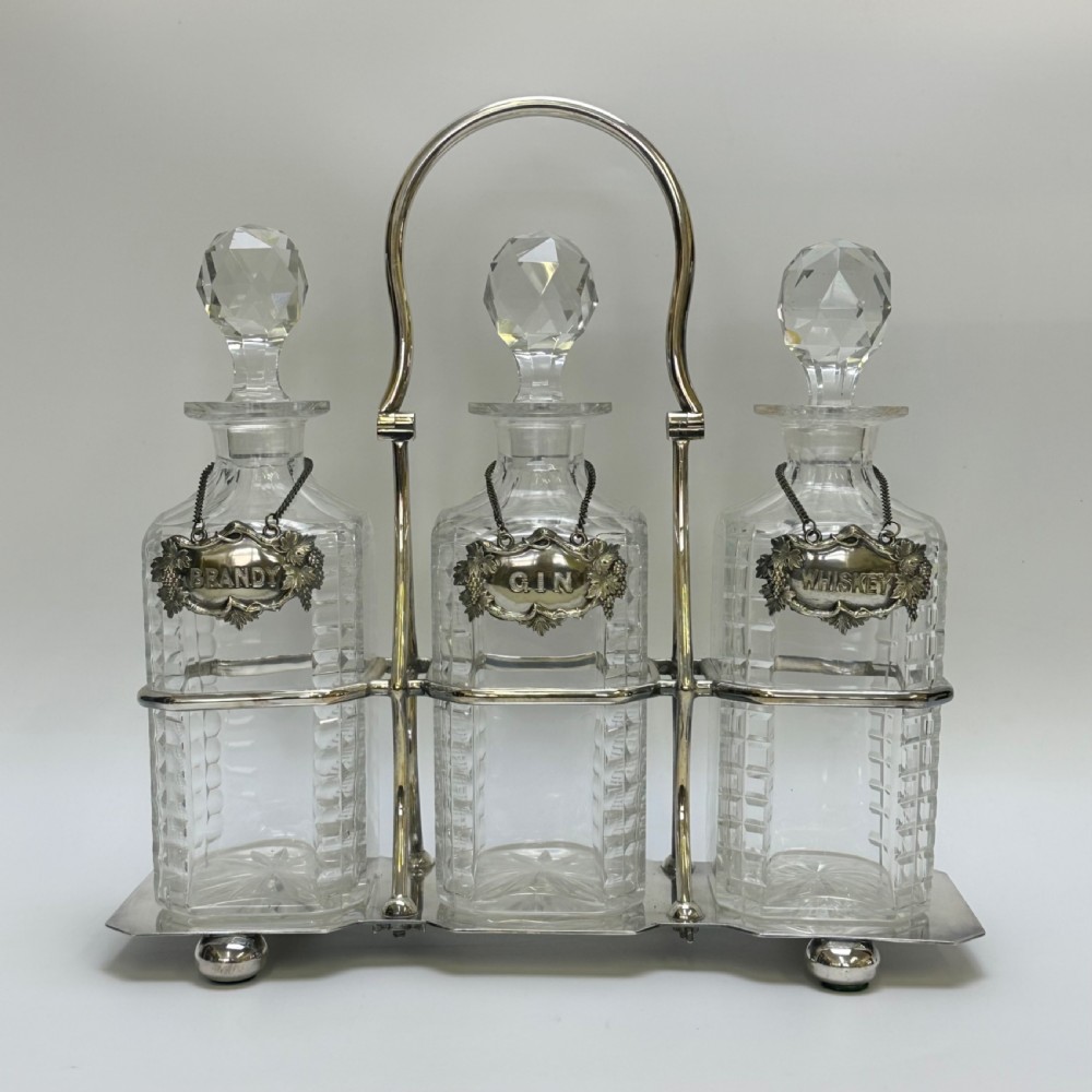 attractive silver plate three decanter tantalus by walker hall with drink labels